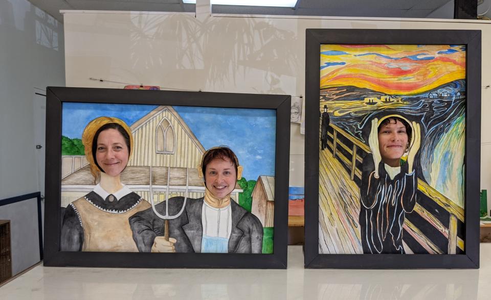 Three women pose in face cut-outs on famous painting replicas