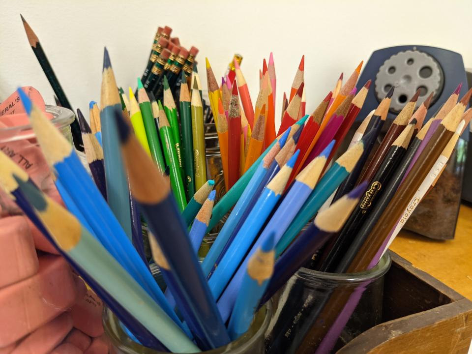 Close-up of an array of colorful pencils and art supplies.
