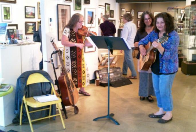 a trio warms up the crowd at the ArtWorks gallery