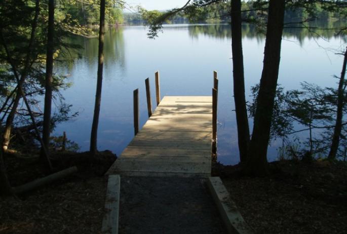 A dock on Follensby Clear Pond providing a picture-perfect start to a popular Adirondack canoe route