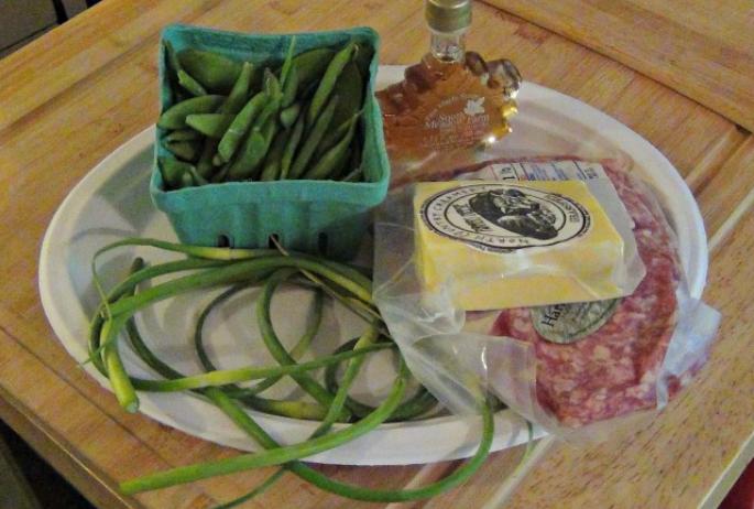sugar snap peas, maple syrup, ground pork, farmer's cheese, and some unknown green things (garlic scapes)