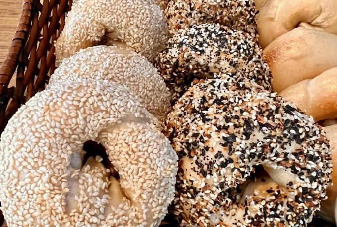 An array of bagels with seeds and plan
