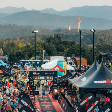 Ironman Lake Placid Finish line with ski jumps and mountains in background