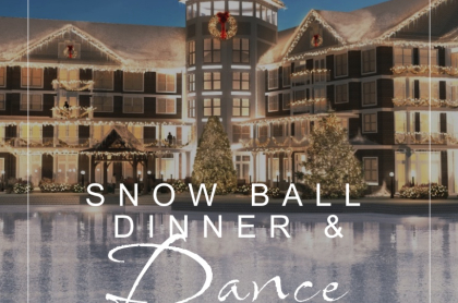 A winter lakeside image of VOCO Saranac Lake lit up with holiday lights