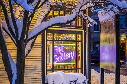 A photo of the gallery's neon lights lit up in the snow
