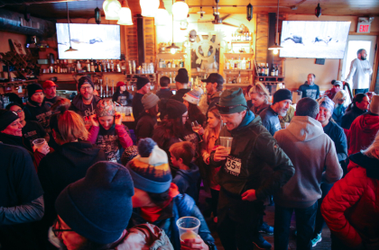 mix of bar patrons in winter weather gear 