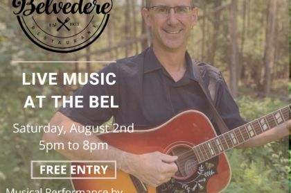 poster of andy holding a guitar with trees in the background