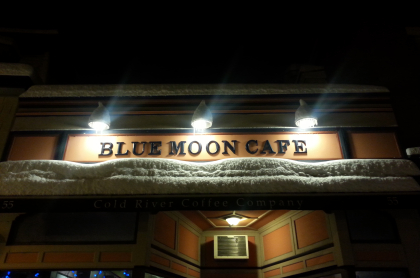 Nighttime view of the exterior of the Blue Moon Cafe in Saranac Lake