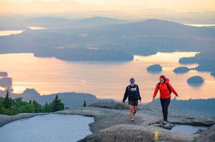 A couple people hiking Ampersand Mountain