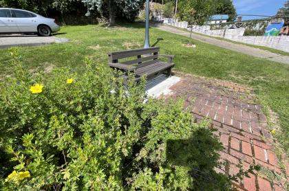 A small park with a bench in the middle of town