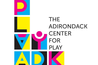 Logo for Play ADK with colorful blocks stacked to spell their name