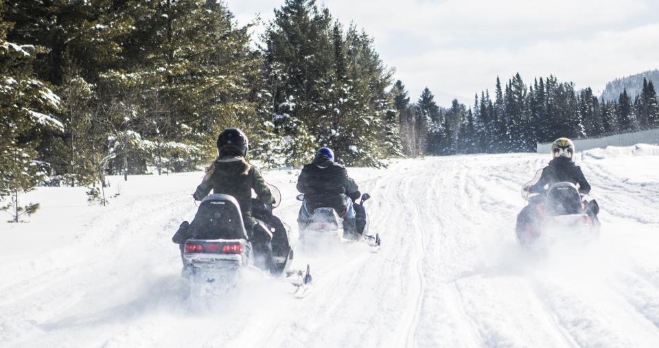 Snowmobiling on a trail.