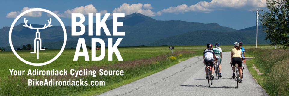 Link to BikeAdirondacks.com with two cyclists on the road.