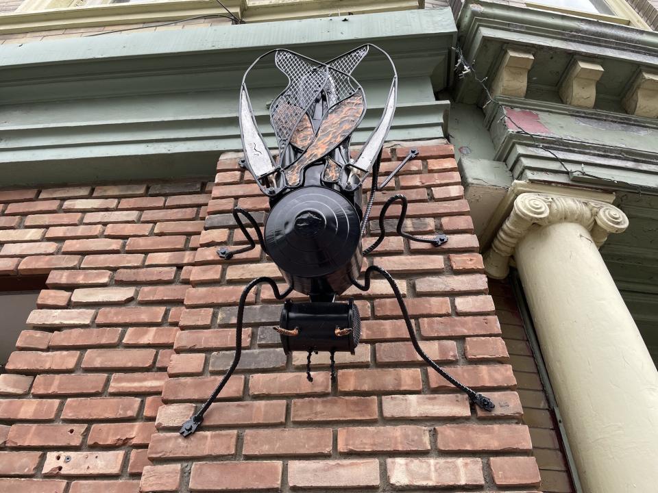 bug sculpture on outside wall