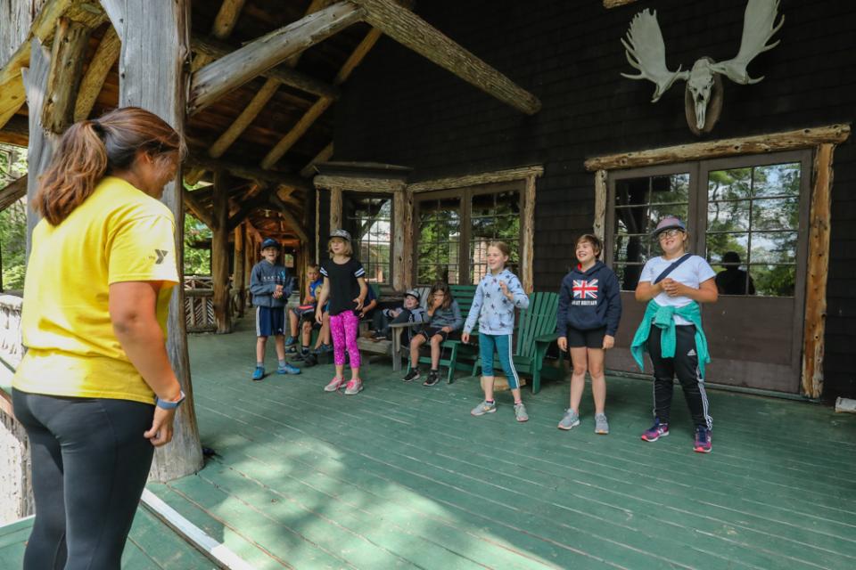 Campers and a counselor at Eagle Island Camp learning a new skill. Photo provided by Eagle Island Camp, Inc.