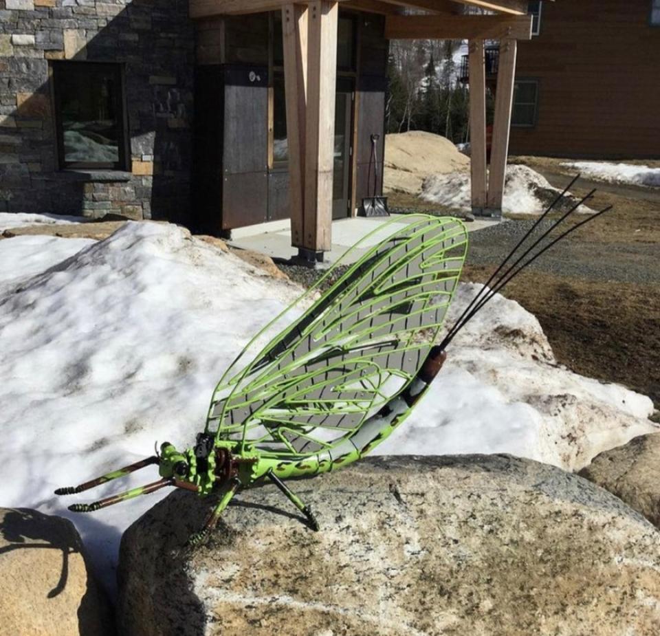 One of the bug sculptures made from scrap metal. It is a fly with green wings.