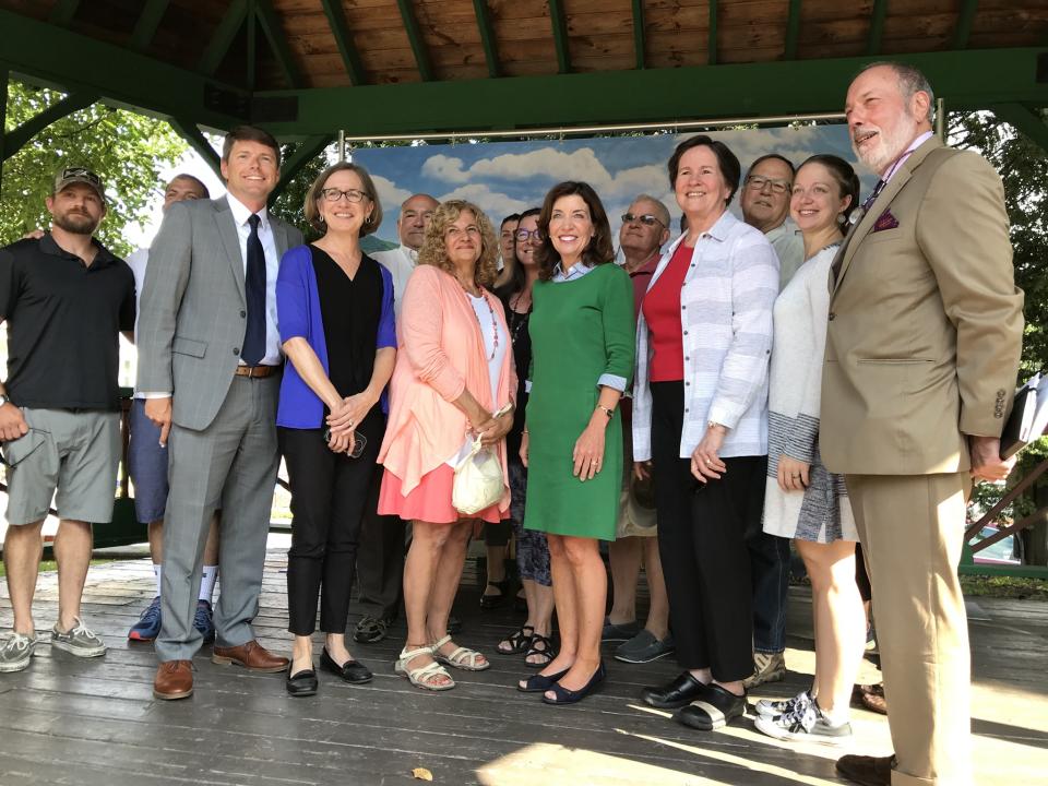 A group of people, including then-Lieutenant Governor Hochul, stand together at the DRI grant ceremony in Saranac Lake