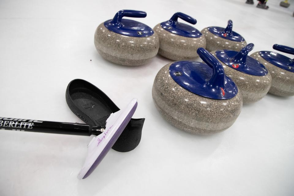 Curling stones sit on ice.