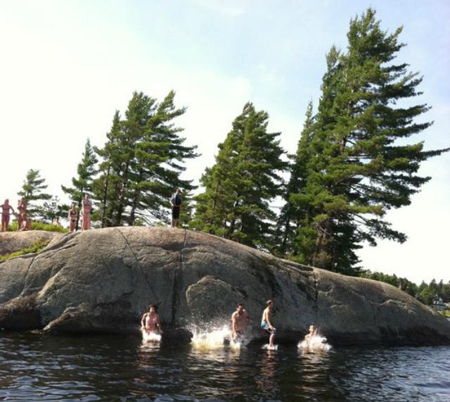 Take the boat to some fantastic destinations, like this famous diving rock on Lower Saranac Lake.