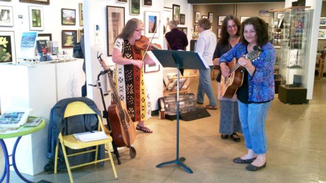 a trio warms up the crowd at the ArtWorks gallery