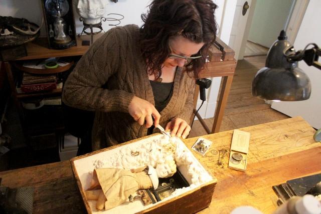 Anastasia Osolin works on an assemblage in her Saranac Lake studio.