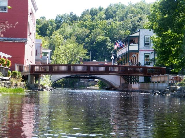 View of a bridge from the center of the Saranac River in downtown Saranac Lake