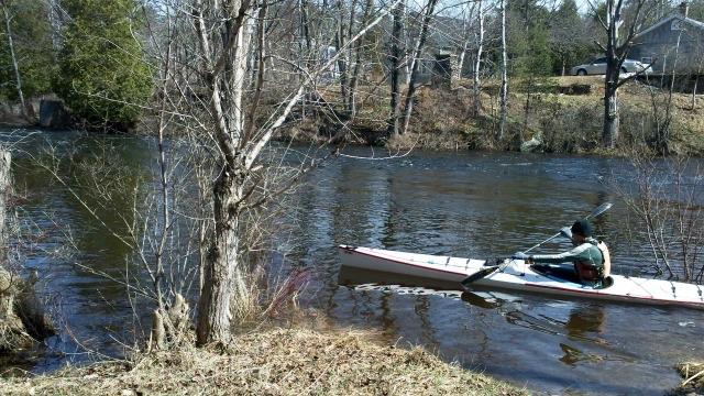 This kayaker is dressed for spring, right up to his warm hat!
