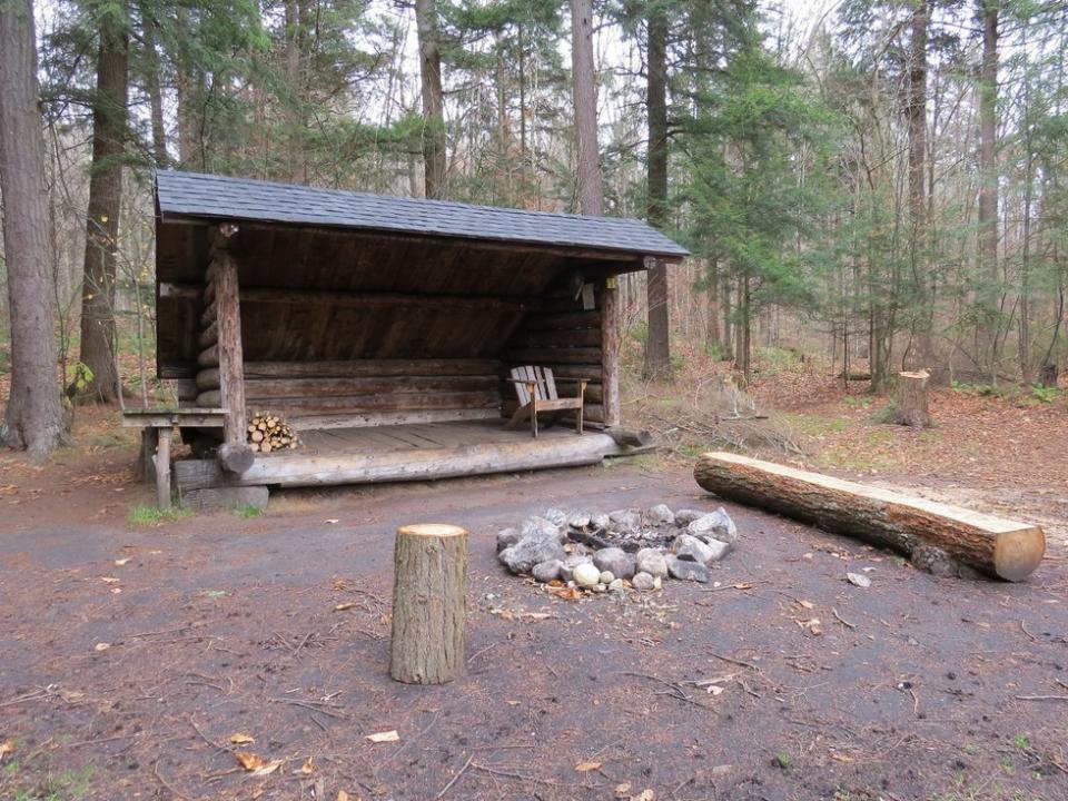 A wooden lean-to is surrounded by trees at Raquette Falls.