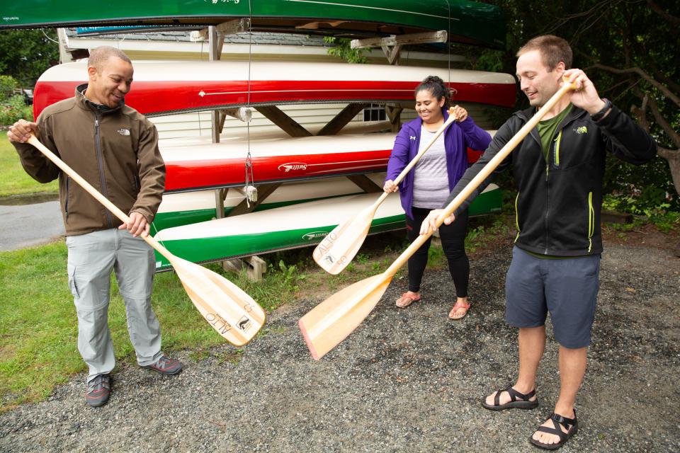 two guests learning to paddle from a guide