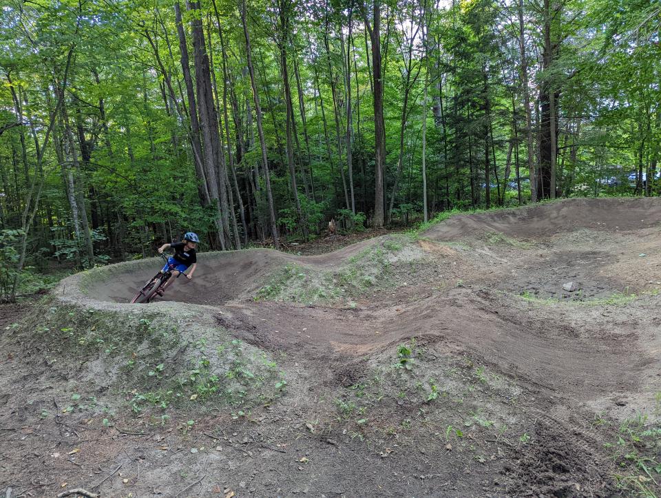 A biker goes around a curve on the pump track