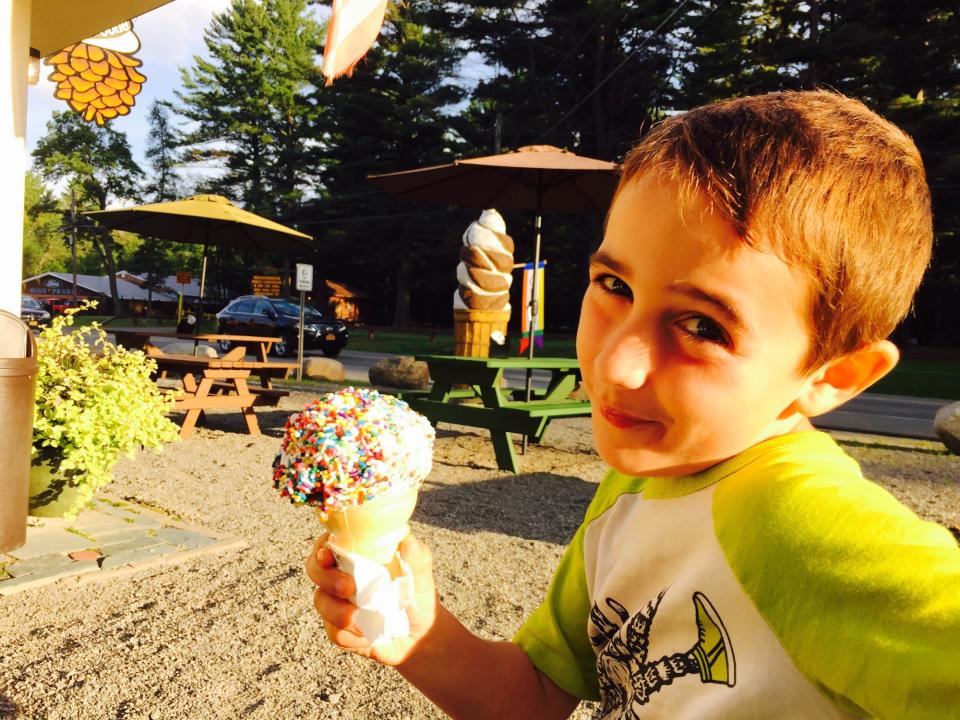 A young kid enjoys an ice cream