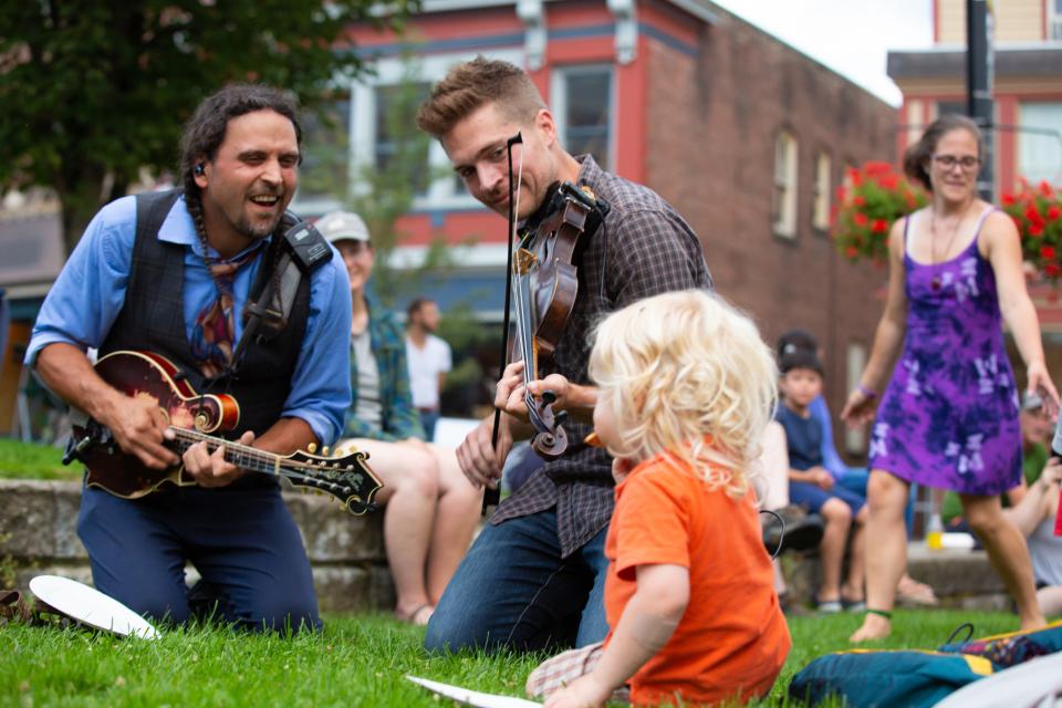 A young kid listens to live music