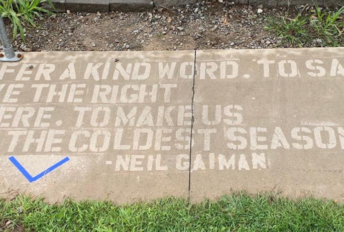 A sidewalk poem written using ink that only appears when it's wet/raining.