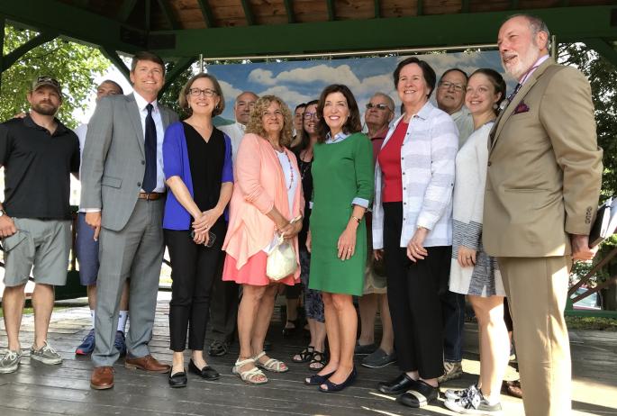 A group of people, including then-Lieutenant Governor Hochul, stand together at the DRI grant ceremony in Saranac Lake