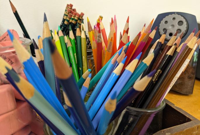 Close-up of an array of colorful pencils and art supplies.