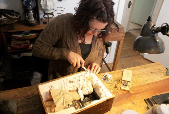 Anastasia Osolin works on an assemblage in her Saranac Lake studio.