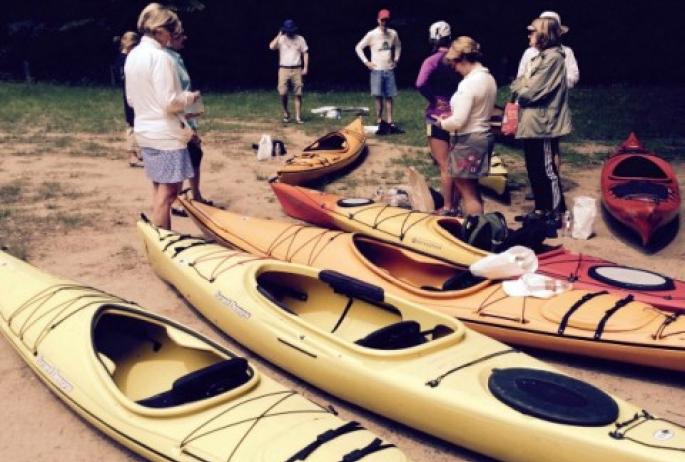 A group of kayakers preparing to embark on an Adirondack kayak trip along what is sure to be their new favorite kayak route.