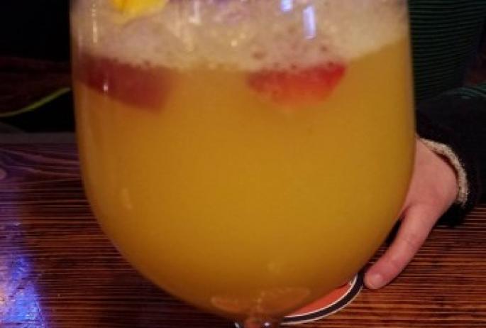 A traditional mimosa with fresh berries