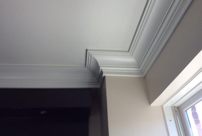 These moldings are more than decorative; they carry all the wiring the walls cannot.