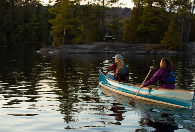 Two women paddling.