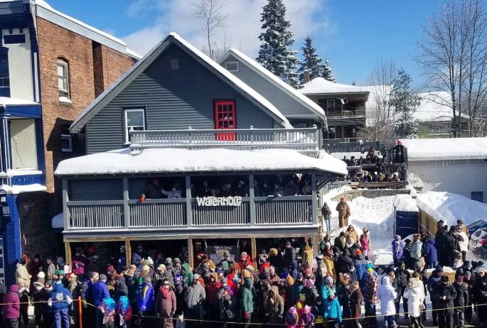People gather outside a three-story bar and live music venue in the winter