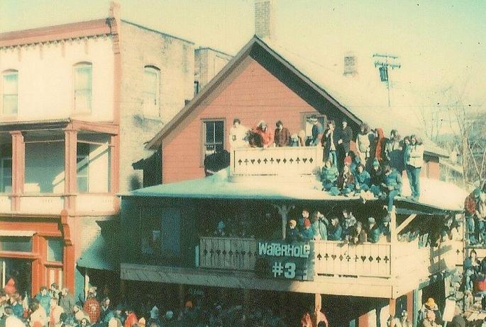 An old photo of a three-story bar packed with people