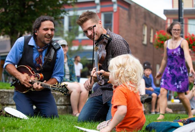 A young kid listens to live music