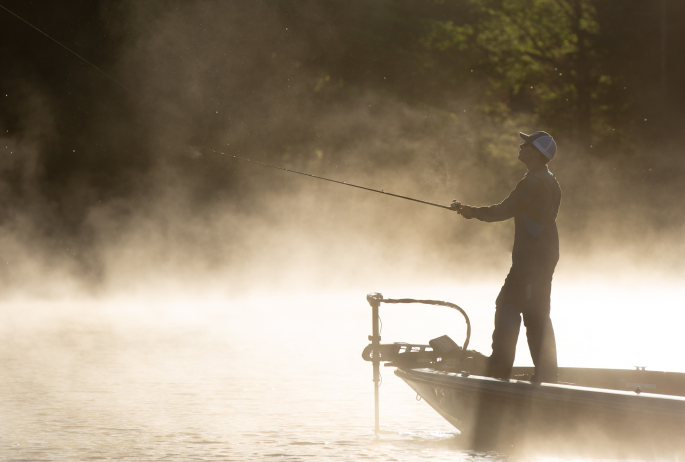 A person fishing in the morning