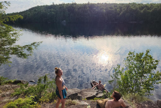 Swimmers on the shore of Moose Pond.