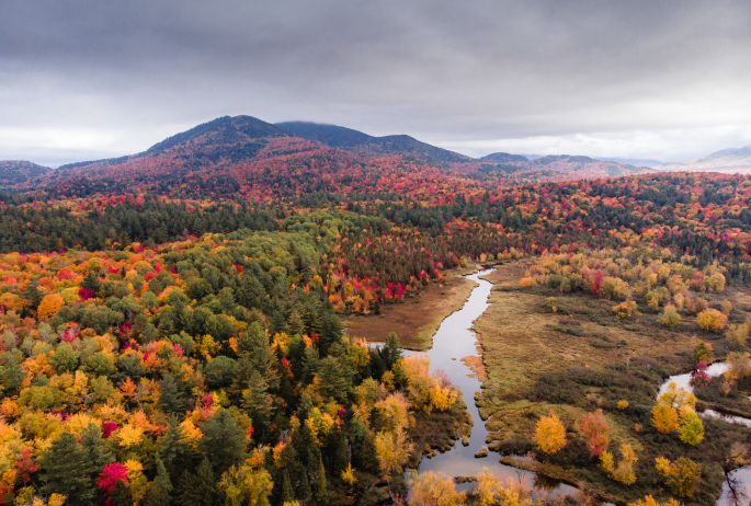 The Osgood River with fall foliage and mountain views.