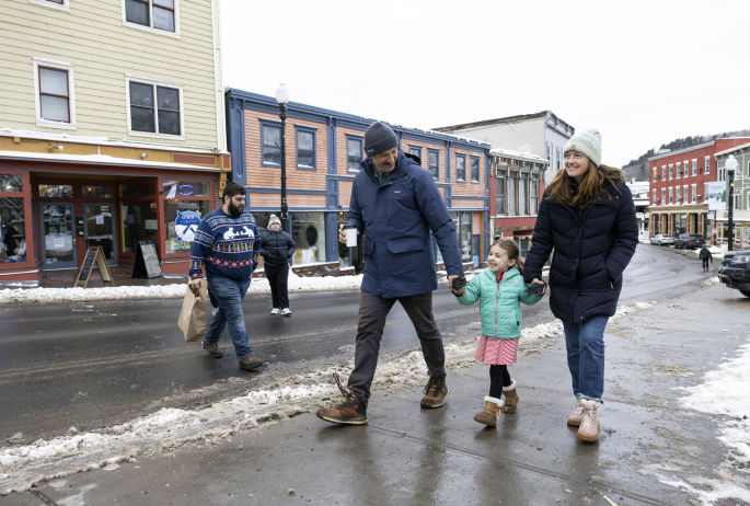 family walking on snowy street