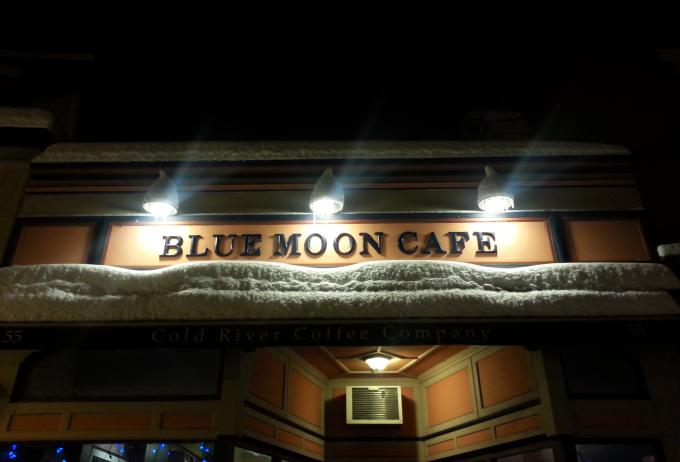 Nighttime view of the exterior of the Blue Moon Cafe in Saranac Lake