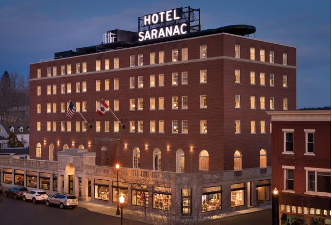 Aerial view of the Hotel Saranac lit up at dusk