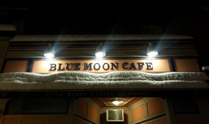 Nighttime view of the exterior of the Blue Moon Cafe in Saranac Lake